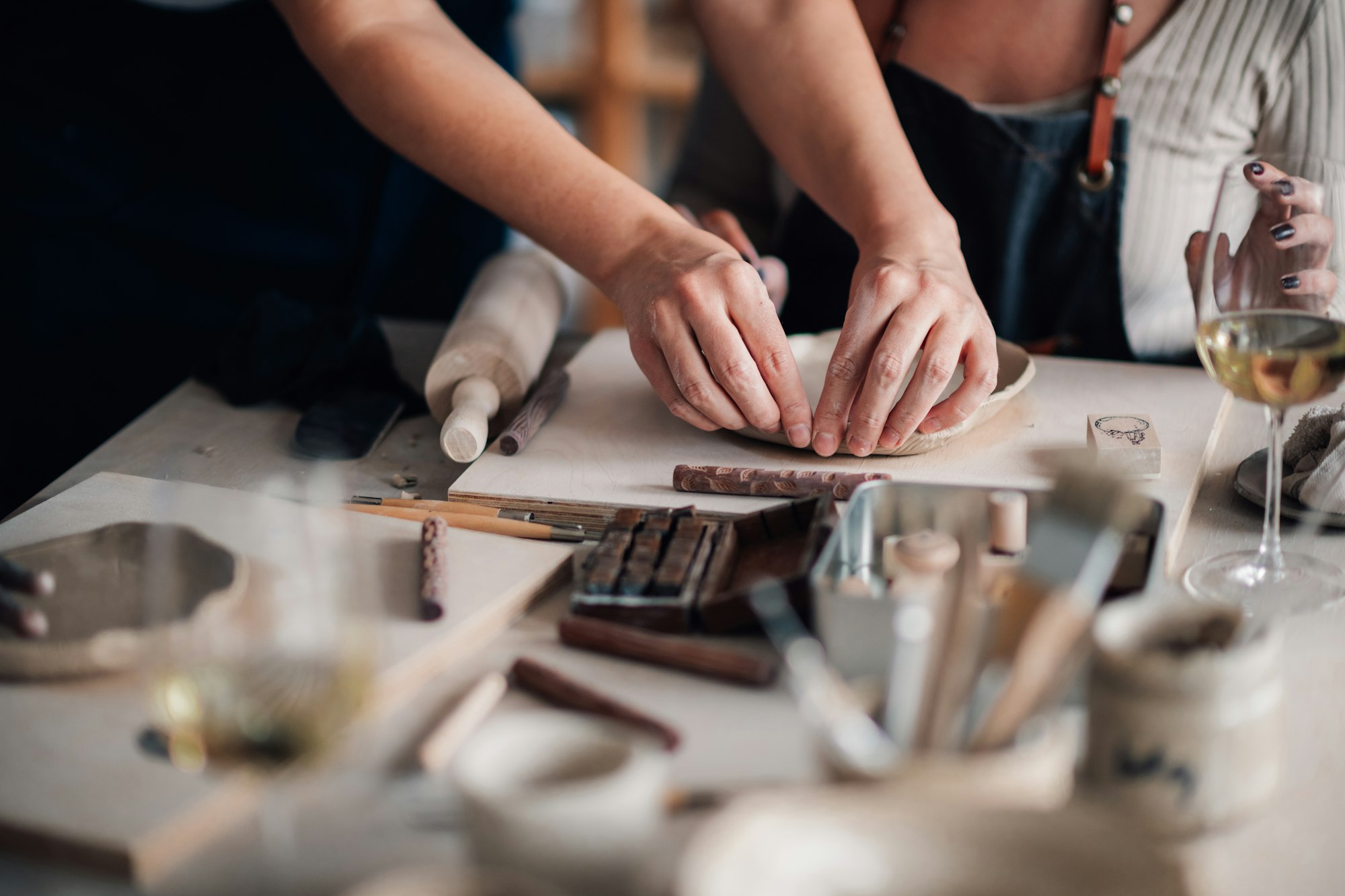 Close up of pottery class instructor demonstrating clay work at workshop