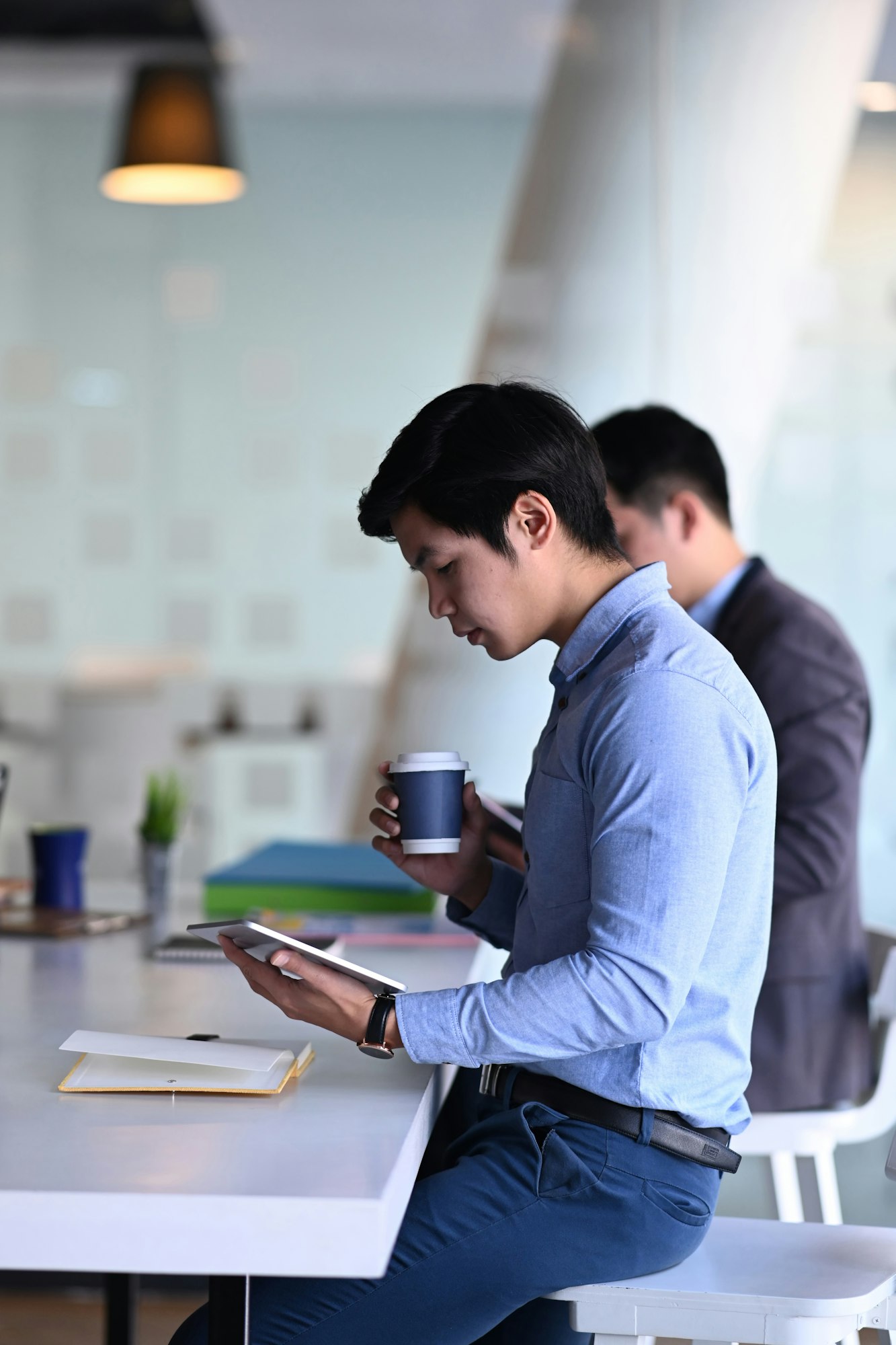 Side view of businessman discussing information and working together in office.