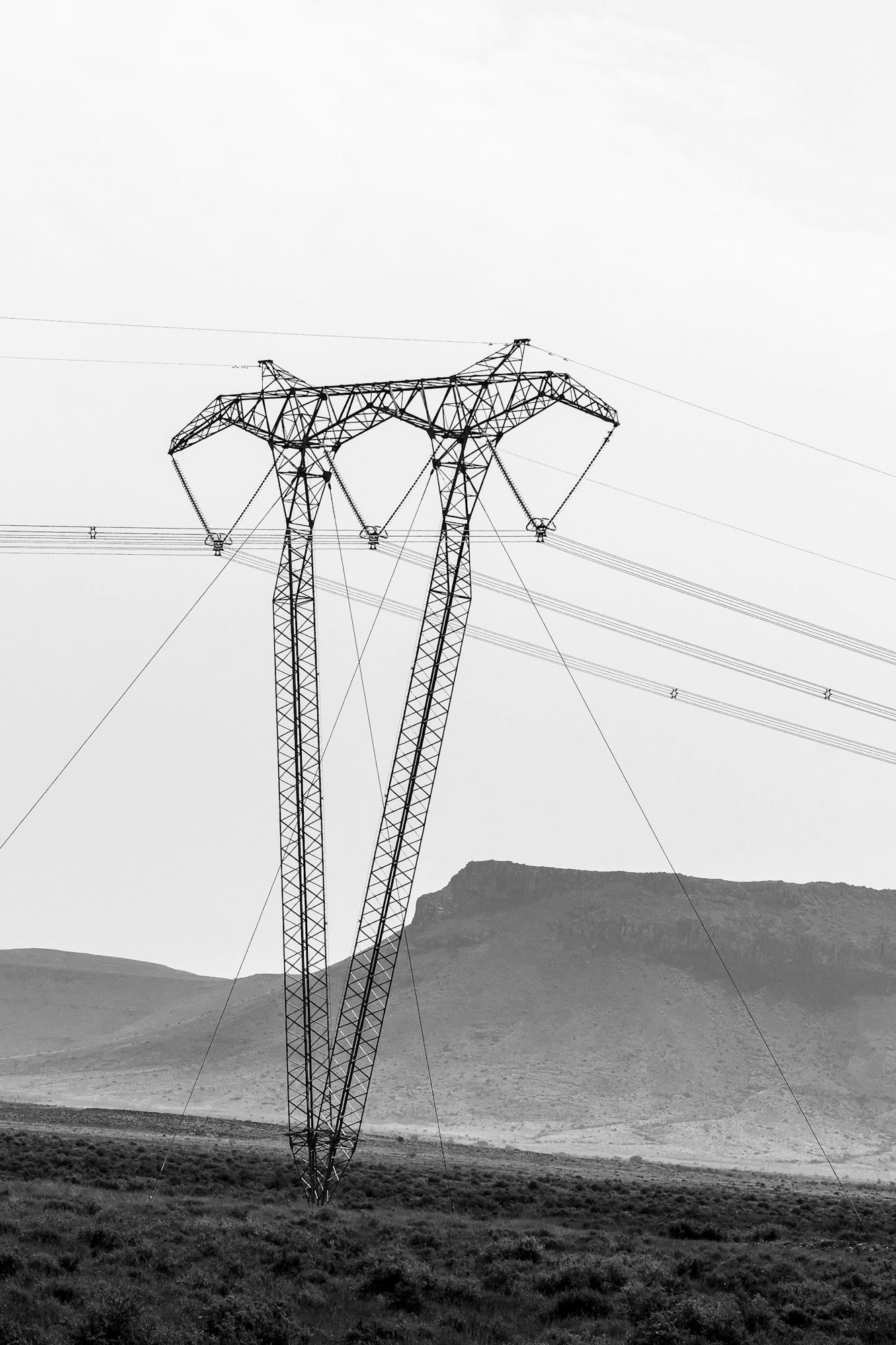 V-type guyed suspension pylon on power transmission line. Monochrome